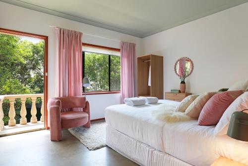 a bedroom with a bed and a large window at Thirroul Beach Apartments in Thirroul
