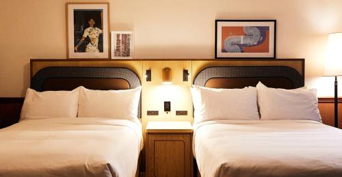 a hotel room with two beds and two lamps at Union Hotel in Toronto