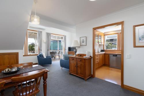 a living room with a table and a dining room at City Apartment South Street in Nelson