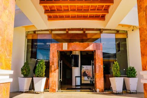 an entrance to a building with potted plants at Hotel Ruinas Resort in Huehuetenango