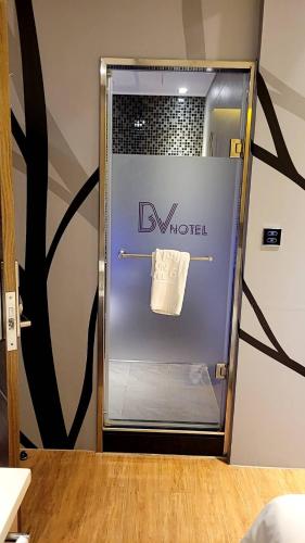 a modern refrigerator with a towel on the door at SIX FUKUN HOTEL in Jiaoxi