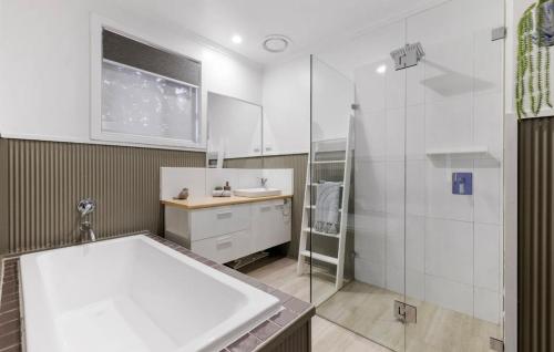 a bathroom with a shower and a sink and a tub at Large Pet Friendly Island Escape in Newhaven