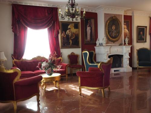 a living room filled with furniture and a window at Castle By The Sea in Artemida