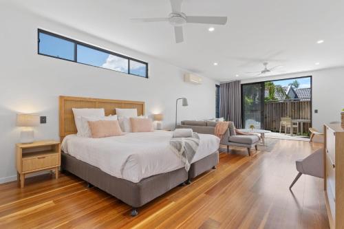 a bedroom with a large bed and a living room at Grottamare in Lennox Head