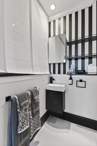 a bathroom with a sink and a mirror at ORCHID SUITES - Historic Palm Beach Hotel Condominium in Palm Beach