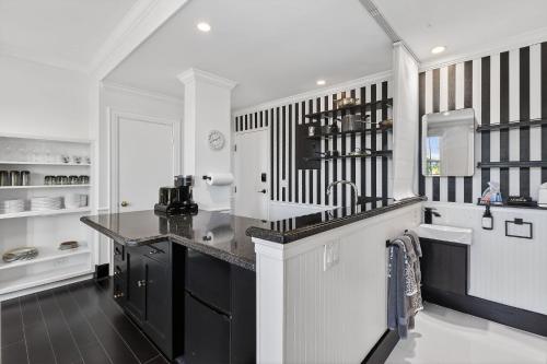 a kitchen with black and white striped walls at ORCHID SUITES - Historic Palm Beach Hotel Condominium in Palm Beach