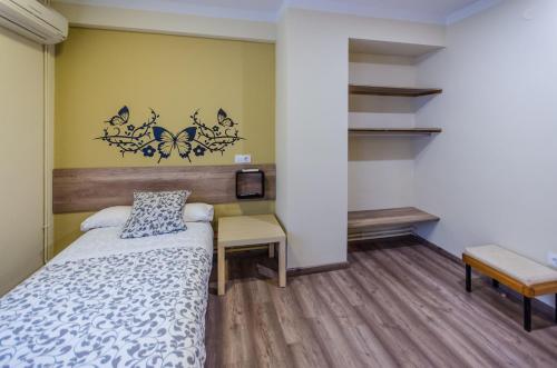 Ένα ή περισσότερα κρεβάτια σε δωμάτιο στο Hostal La Pastora