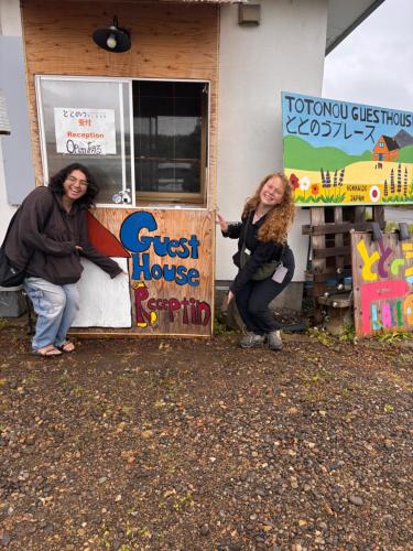 two women are standing in front of a guest house at TOTONOU Place in Asahikawa