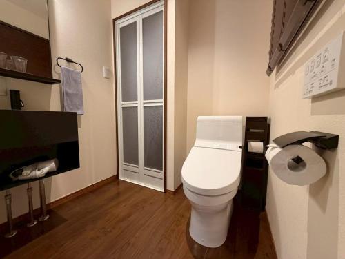 a bathroom with a white toilet in a room at ura Kyunoju in Okayama