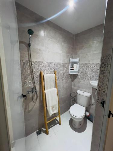 a small bathroom with a toilet and a shower at Riad Nomad House Marrakech in Marrakesh