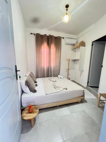 a bedroom with a large bed in a room at Riad Nomad House Marrakech in Marrakesh