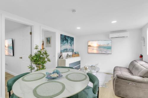 a living room with a table and a couch at The Oasis Signature in Miami
