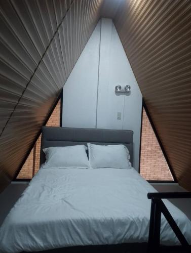 a bedroom with a large bed in a room at H&P Beach Resort in Pandan