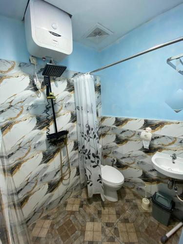 a bathroom with a toilet and a sink at Wel home stay in Pulau Gilimota