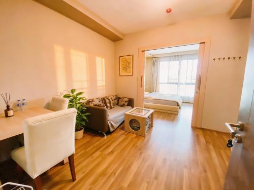 a living room with a couch and a table at treasure swimming condo in Chiang Mai