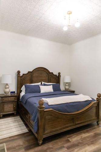 a bedroom with a large bed with blue sheets at Historic Market Plaza Overlook in Wheeling
