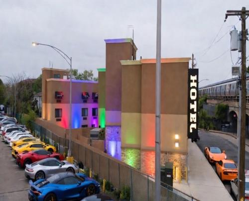 a row of cars parked in front of a building at Hotel Mint JFK Airport in Queens