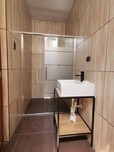 a bathroom with a white sink and a shower at Casa Arena & Sol in Santa Rosa