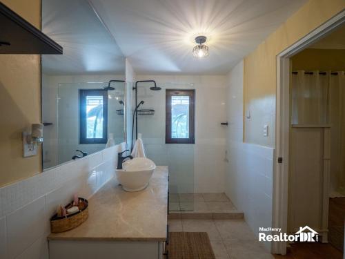 a bathroom with a sink and a mirror at Casa Estrella, Relaxation Begins in Sosúa