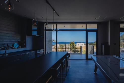 a kitchen with a large counter and a large window at Luxury Villa Maeda Unit2 in Onna