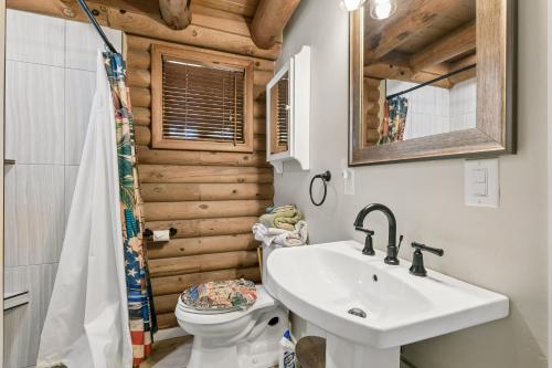 a bathroom with a white sink and a toilet at Forest Hideaway Near Sedona in Munds Park