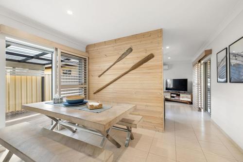 a dining room with a wooden wall at Pet Friendly Beachside Hideaway - Lazy on Lowry in Woorim