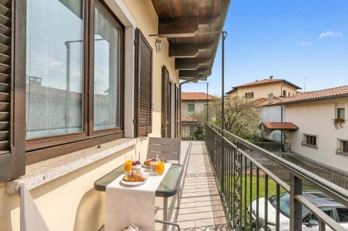 a balcony with a table with food and drinks on it at Sunset in Baveno: 1 Bed with Balcony - Happy Rentals in Baveno