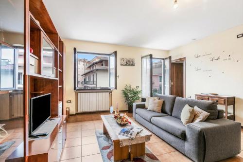 a living room with a couch and a tv at Sunset in Baveno: 1 Bed with Balcony - Happy Rentals in Baveno
