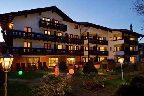 a large building with lights on in the night at Hotel Hirsch in Oberstaufen