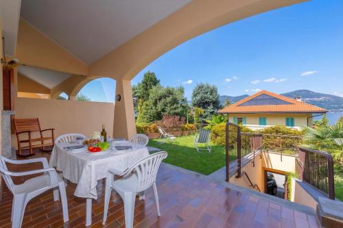 a patio with a table and chairs on a balcony at Sunset in Ranco: Lakeview Townhouse with Private Garden - Happy Rentals in Ranco