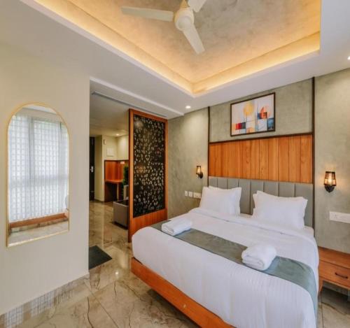 a bedroom with a large bed in a room at Hotel Morya Suites IGI Airport in New Delhi