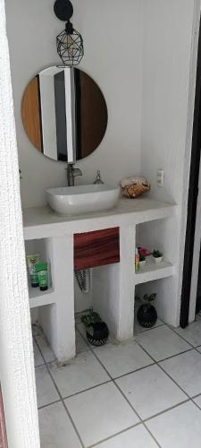 a bathroom with a sink and a mirror at descanso ideal con alberca in Cihuatlan