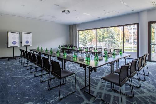 a large conference room with a long table and chairs at Novotel Wrocław Centrum in Wrocław
