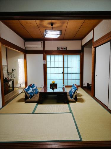 a room with two chairs and a table in it at Via Tsuru鶴苑1 minute from the station! in Izumi-Sano
