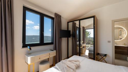 a bedroom with a bed and a sink and a mirror at Vila Laguna Blu by Villas Guide in Trget