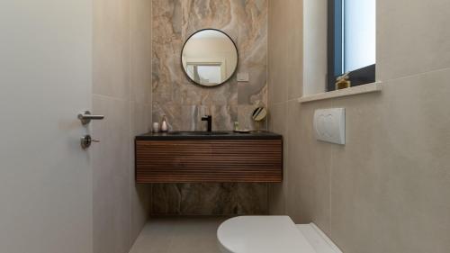 a bathroom with a sink and a mirror at Vila Laguna Blu by Villas Guide in Trget