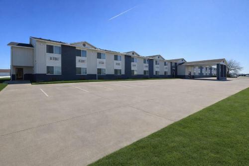 a large building with a parking lot in front of it at Super 8 by Wyndham Smithville Kansas City in Smithville