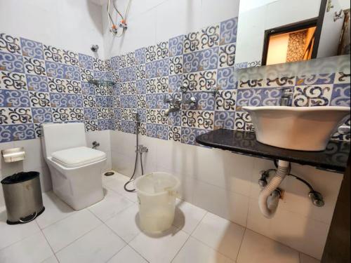 a bathroom with a toilet and a sink at Hotel Raunak in Kolkata