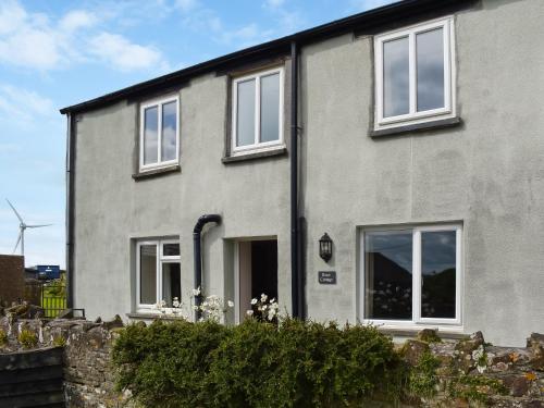 a gray house with white windows and a fence at Uk47757 - Rose Cottage in Launceston