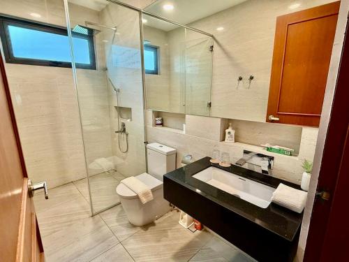 a bathroom with a toilet and a sink and a shower at Villa Alam Klang managed by Bella Vista Hotels & Resorts in Klang