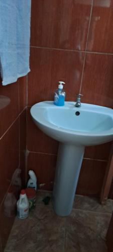 a bathroom with a white sink in a room at CLAUDIA Blessings in Saint Gabriel