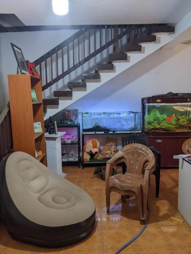 a living room with a stairs and an aquarium at flying in stay in Dankotuwa