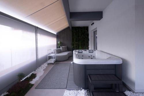 a bathroom with a bath tub and a sink at Edem in Larisa