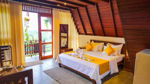 a bedroom with a bed with yellow and white sheets at Cinnamon Crown in Matara