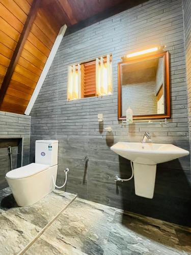 a bathroom with a sink and a toilet at Cinnamon Crown in Matara