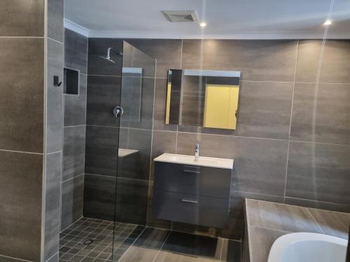 a bathroom with a sink and a shower at Frankie's Nest in Cape Town