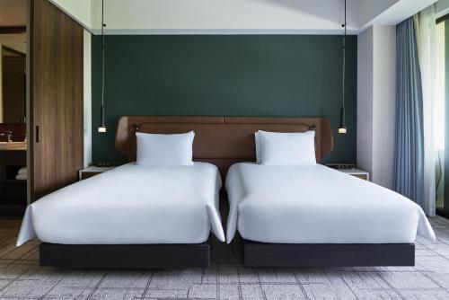 two beds sitting next to each other in a room at Fuji Speedway Hotel, in The Unbound Collection by Hyatt in Oyama