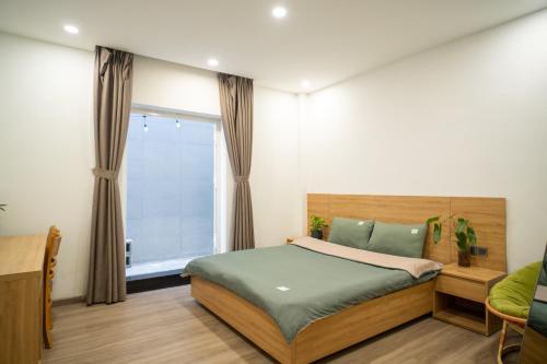 a bedroom with a bed and a window at Dahill 196 Dalat in Da Lat