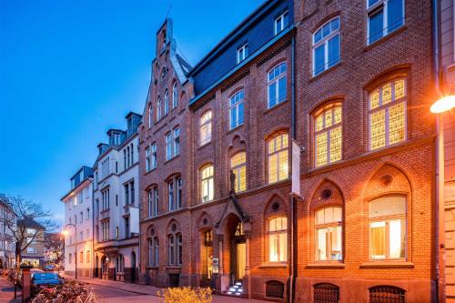 a large brick building on the side of a street at Hopper Hotel St. Josef, WorldHotels Crafted in Cologne