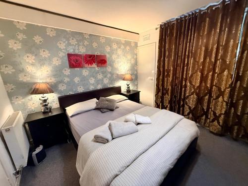 a bedroom with two beds with white pillows at Likewise Modern Two bedrooms Home for 4 in Glasgow Area in Pollokshaws